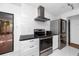 Contemporary kitchen with stainless appliances, granite countertops, and subway tile backsplash at 15718 Squirrel Tree Pl, Tampa, FL 33624