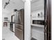 Modern kitchen featuring stainless steel appliances and a walk-in pantry at 15718 Squirrel Tree Pl, Tampa, FL 33624
