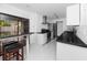 Bright kitchen with stainless appliances and breakfast bar leading to an outdoor deck at 15718 Squirrel Tree Pl, Tampa, FL 33624