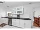 Modern kitchen with stainless steel appliances, granite counters, and white cabinetry at 15718 Squirrel Tree Pl, Tampa, FL 33624