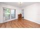 Clean living room with wood floors, neutral paint and a built in storage unit at 15718 Squirrel Tree Pl, Tampa, FL 33624