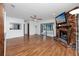 Spacious living room with wood floors, brick fireplace, and view of the kitchen and sunroom at 15718 Squirrel Tree Pl, Tampa, FL 33624