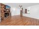 Cozy living room with wood floors, brick fireplace, and abundant natural light at 15718 Squirrel Tree Pl, Tampa, FL 33624