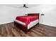 Spacious main bedroom featuring wood floors and a ceiling fan at 15718 Squirrel Tree Pl, Tampa, FL 33624