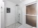 Modern walk-in shower with pebble floor and gray tile at 15718 Squirrel Tree Pl, Tampa, FL 33624