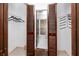 Walk-in closet with wood-slatted doors leading to the en-suite bathroom at 15718 Squirrel Tree Pl, Tampa, FL 33624