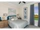 Comfortable bedroom features soft carpet, a ceiling fan, and a window with a golf course view at 16404 Isola Pl, Bradenton, FL 34211