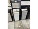 Selection of white and gray cabinetry with modern hardware, showcasing various flooring samples at 16404 Isola Pl, Bradenton, FL 34211