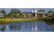 Scenic community entrance with gatehouse, palm trees, and lush landscaping, creating an elegant and welcoming first impression at 16404 Isola Pl, Bradenton, FL 34211