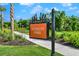 Community park entrance with 'Vitality Park' sign, manicured landscaping, and paved walkway, showcasing a welcoming outdoor space at 16404 Isola Pl, Bradenton, FL 34211