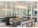 Dining area with modern lighting fixture, table set for six, and mirrored wall at 16404 Isola Pl, Bradenton, FL 34211