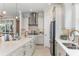 A gourmet kitchen boasting stainless steel appliances, light cabinets, and stone countertops at 16404 Isola Pl, Bradenton, FL 34211