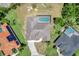 Aerial view features a home with screened pool, near homes with solar panels and well-manicured landscaping at 168 Wading Bird Dr, Venice, FL 34292