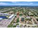 Wide aerial view of home in residential neighborhood with pond and blue apartment complex in the distance at 168 Wading Bird Dr, Venice, FL 34292