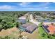 Aerial view showcases a home with a screened pool, nestled in a neighborhood near a scenic pond at 168 Wading Bird Dr, Venice, FL 34292