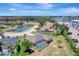 Aerial view of a home with a screened-in pool, situated within a residential neighborhood with a nearby pond at 168 Wading Bird Dr, Venice, FL 34292