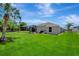 Expansive backyard featuring a well-maintained lawn and a screened-in pool area for outdoor enjoyment at 168 Wading Bird Dr, Venice, FL 34292