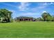 Large, green backyard features a screened-in pool area perfect for outdoor relaxation at 168 Wading Bird Dr, Venice, FL 34292