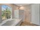 A luxurious bathroom featuring soaking tub and marble shower stall at 168 Wading Bird Dr, Venice, FL 34292