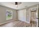 Bedroom featuring wood-look flooring, closet, and window with a backyard view at 168 Wading Bird Dr, Venice, FL 34292