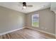 Inviting bedroom with ceiling fan, wood-look flooring, and a bright window at 168 Wading Bird Dr, Venice, FL 34292