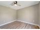 Comfortable bedroom featuring wood-look flooring and a modern ceiling fan at 168 Wading Bird Dr, Venice, FL 34292