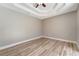 Neutral bedroom with wood floors and a decorative ceiling fan at 168 Wading Bird Dr, Venice, FL 34292
