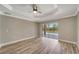 A bright bedroom featuring hardwood floors and crown molding at 168 Wading Bird Dr, Venice, FL 34292
