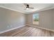 Well-lit bedroom featuring wood-look floors and a window with outside views at 168 Wading Bird Dr, Venice, FL 34292