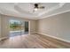 A bright bedroom features hardwood floors and a large sliding glass door to the pool at 168 Wading Bird Dr, Venice, FL 34292