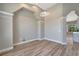 Bright dining room featuring wood floors, neutral walls, and modern lighting fixtures at 168 Wading Bird Dr, Venice, FL 34292