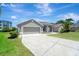 Lovely one story home has an attached two-car garage and concrete driveway at 168 Wading Bird Dr, Venice, FL 34292