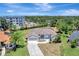 Aerial view of home with lush landscaping, circular driveway, and close proximity to local amenities at 168 Wading Bird Dr, Venice, FL 34292