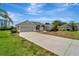 Inviting home with a concrete driveway and a well-maintained lawn, near condos at 168 Wading Bird Dr, Venice, FL 34292