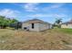 Exterior view of the home, showcasing the screened-in pool and lush backyard at 168 Wading Bird Dr, Venice, FL 34292