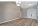 Open-concept space with light wood floors leading to double doors and vaulted ceilings at 168 Wading Bird Dr, Venice, FL 34292