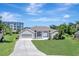 Charming single-Gathering home featuring an attached two-car garage, arched entryways, and verdant lawn at 168 Wading Bird Dr, Venice, FL 34292