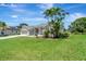 Beautiful one story home with lawn, palm trees, and an attached garage at 168 Wading Bird Dr, Venice, FL 34292
