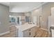 Bright kitchen with white cabinetry, quartz countertops, and stainless appliances and undermount sink at 168 Wading Bird Dr, Venice, FL 34292