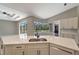 Bright kitchen featuring white cabinetry, quartz countertops, stainless appliances, and a view of the pool at 168 Wading Bird Dr, Venice, FL 34292