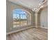 Open living area with large windows, stylish lighting, and modern wood-look floors at 168 Wading Bird Dr, Venice, FL 34292