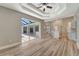Open concept living room with kitchen, wood floors, and a view of the pool at 168 Wading Bird Dr, Venice, FL 34292
