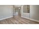 Spacious living room featuring wood floors, neutral walls, and an open layout leading to the outdoor pool area at 168 Wading Bird Dr, Venice, FL 34292