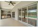 A spacious patio with outdoor kitchen and sliding glass doors at 168 Wading Bird Dr, Venice, FL 34292