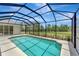 A screened-in pool with view of the pool and surrounding community at 168 Wading Bird Dr, Venice, FL 34292