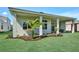 Covered outdoor living space, featuring a built-in outdoor kitchen area overlooking a well-maintained lawn at 17719 Palmiste Dr, Bradenton, FL 34202