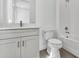 Bright bathroom featuring white subway tile in the shower, a toilet, and a vanity sink at 17719 Palmiste Dr, Bradenton, FL 34202