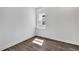 Modern bedroom with dark wood floors, white walls, and a window at 17719 Palmiste Dr, Bradenton, FL 34202
