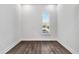 Empty room with dark wood floors, white walls, and a window with neighborhood views at 17719 Palmiste Dr, Bradenton, FL 34202