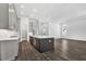 Well-lit kitchen showcases a large island with a sink, modern cabinets, and hardwood floors at 17719 Palmiste Dr, Bradenton, FL 34202